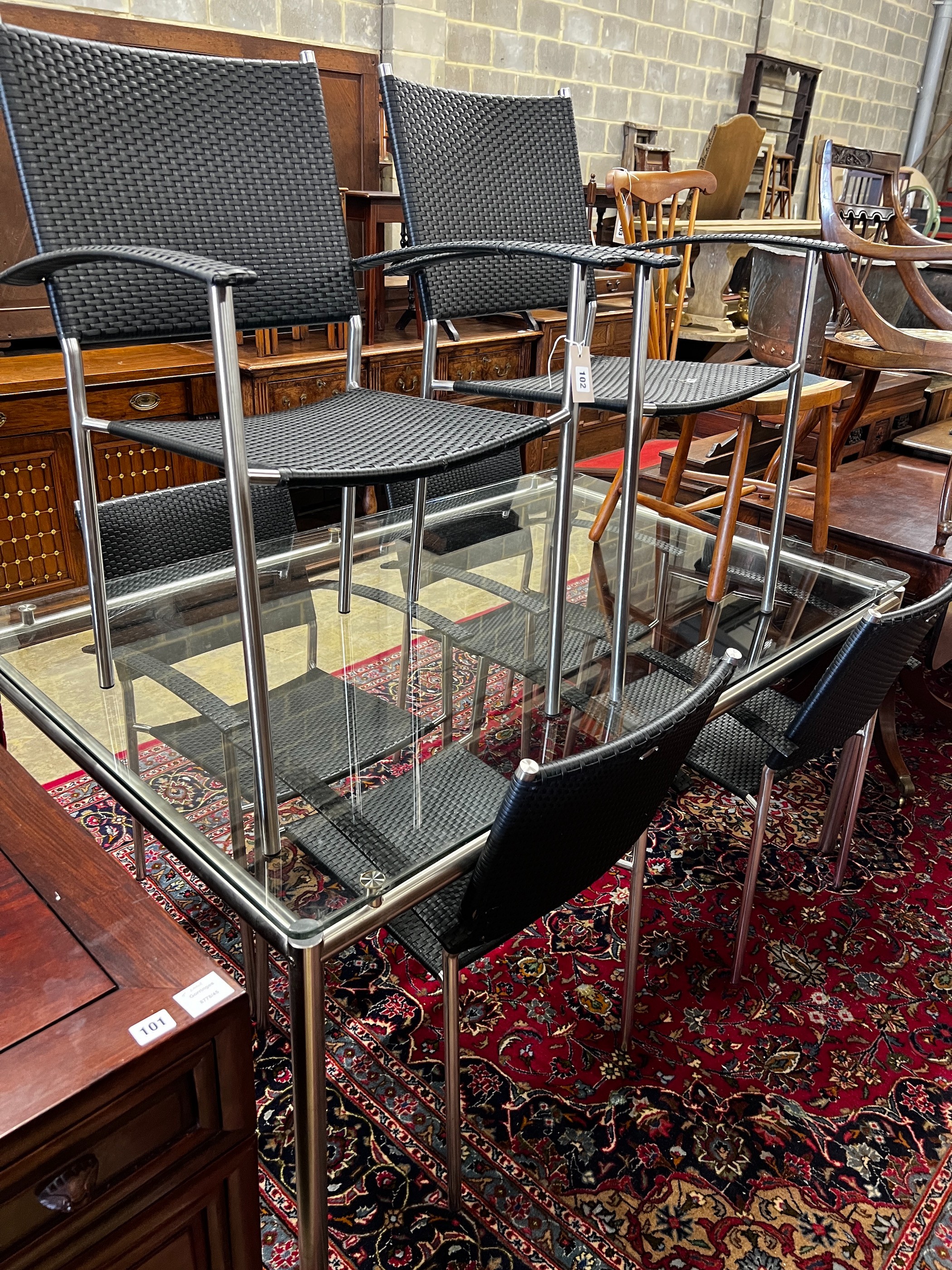 A contemporary Alexander Rose rectangular glass top garden table, length 159cm, depth 100cm, height 73cm and six 'all weather' rattan chairs, all with arms